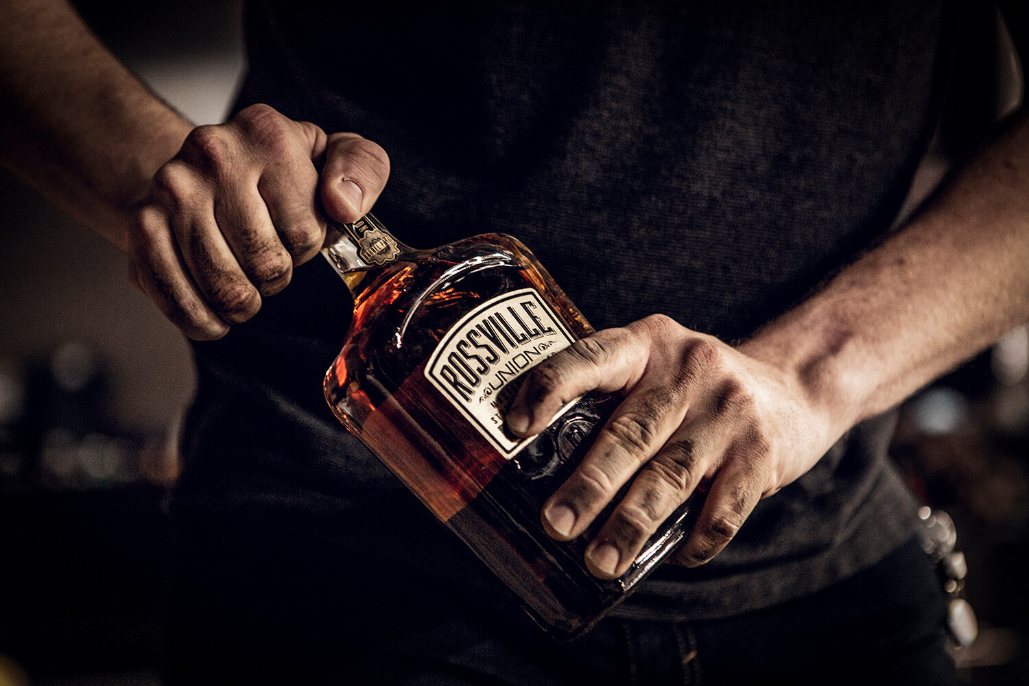 hand opening bottle of rossville